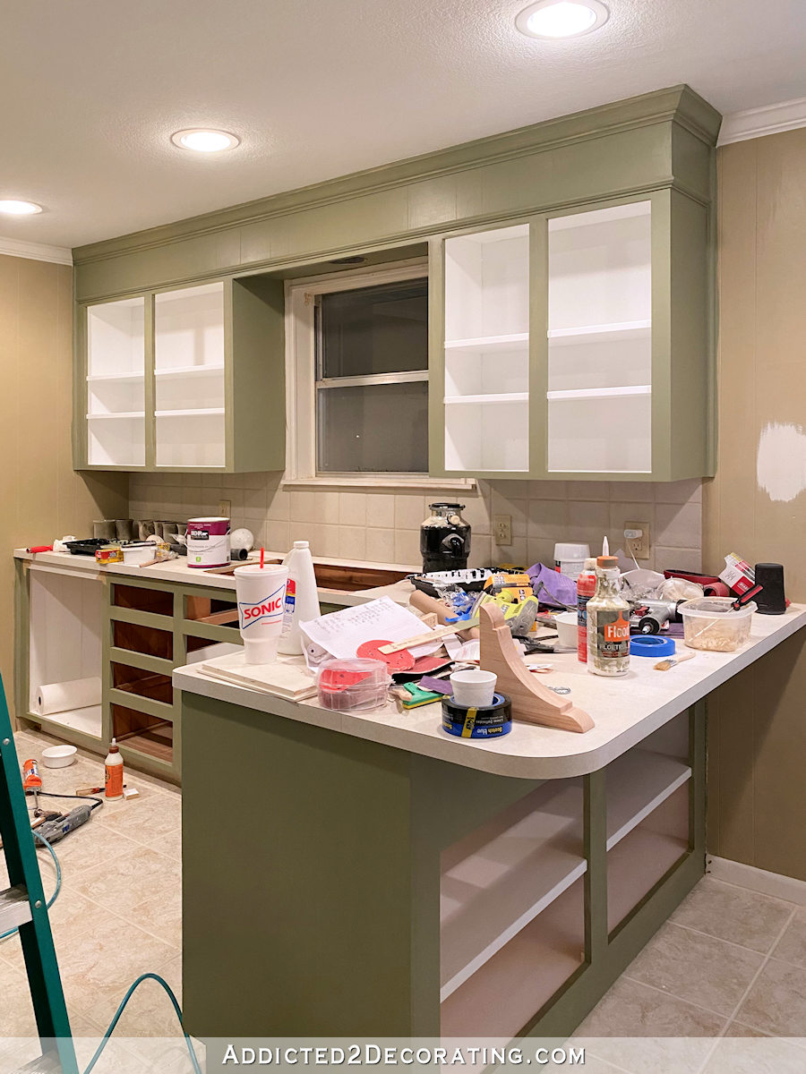 mom's kitchen makeover - first coat of paint on the cabinets - sink and window wall