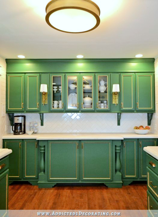 green kitchen with glass front upper cabinets