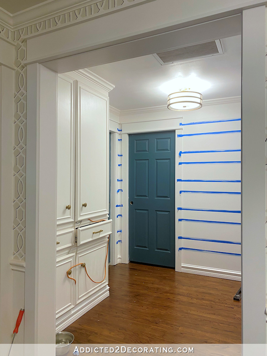 hallway progress - wall taped off to paint stripes - 3