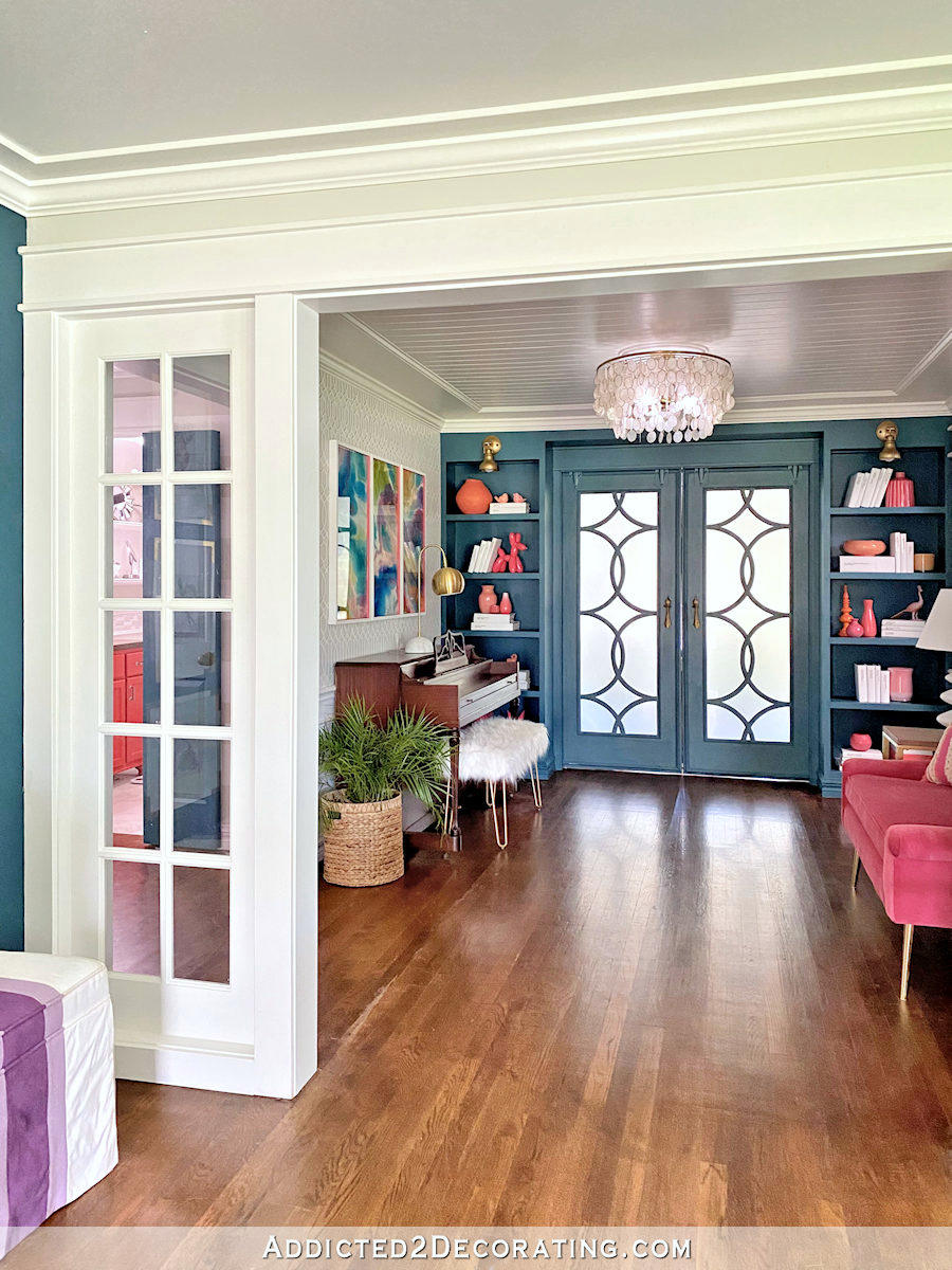 wide cased opening between entryway and music room, custom French doors hung on barn door hardware