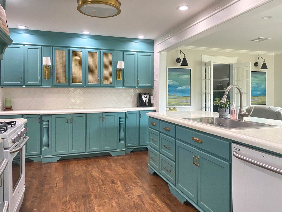 kitchen with teal cabinets and white concrete countertops