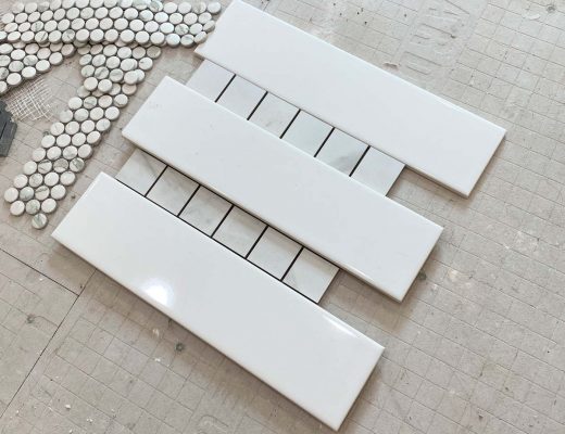 master bathroom shower tile options - striped tile with large white rectangle and small square marble tile