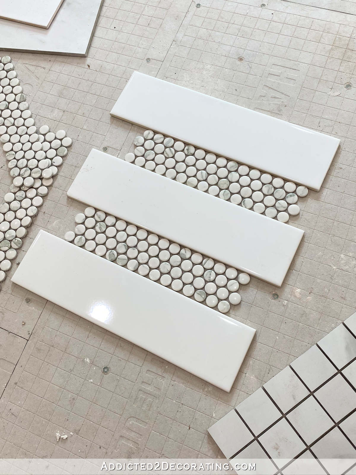 master bathroom shower tile options - white rectangle tile with marble penny tile accent