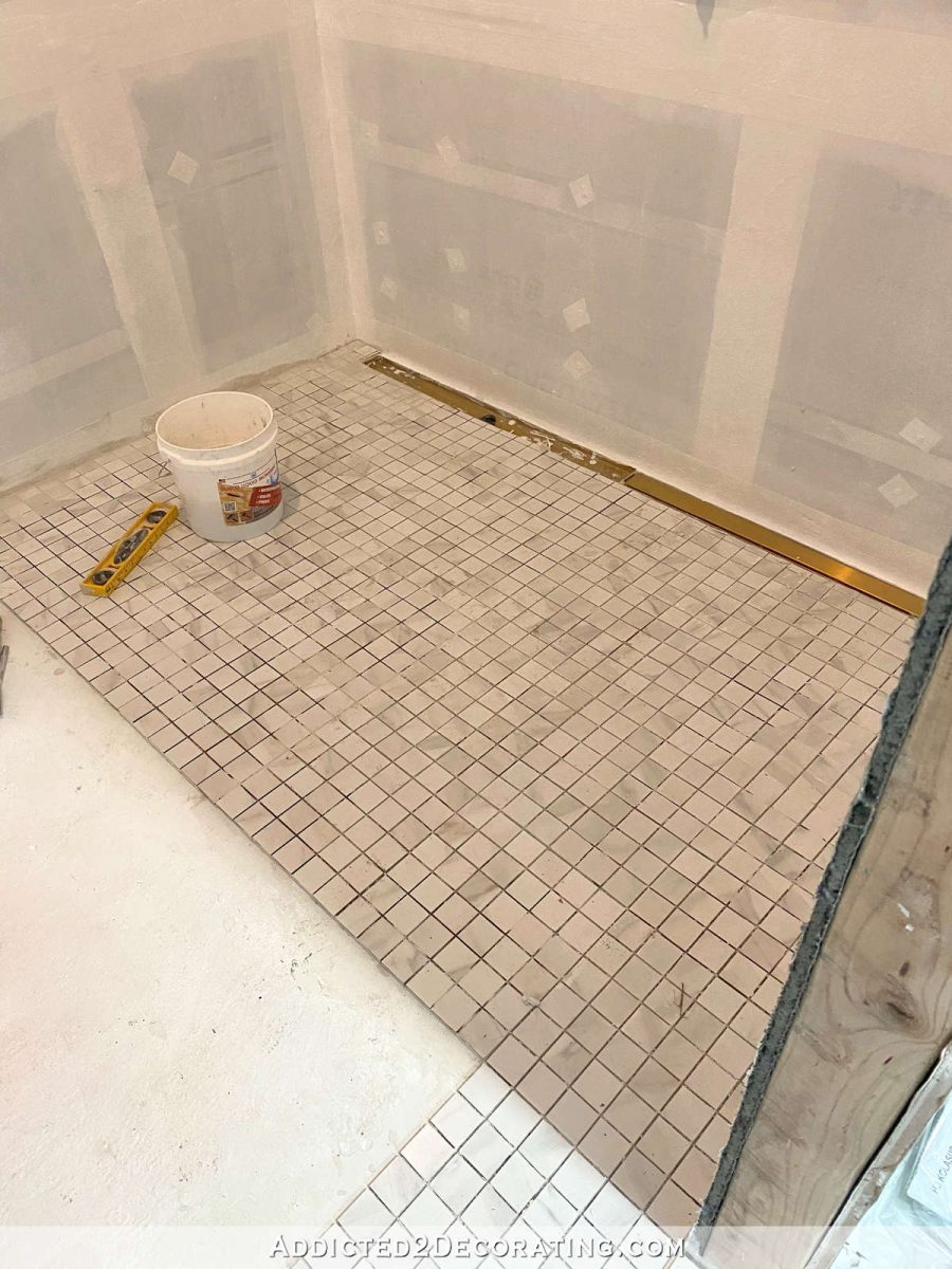 large curbless shower floor tiled with 2 x 2 tile