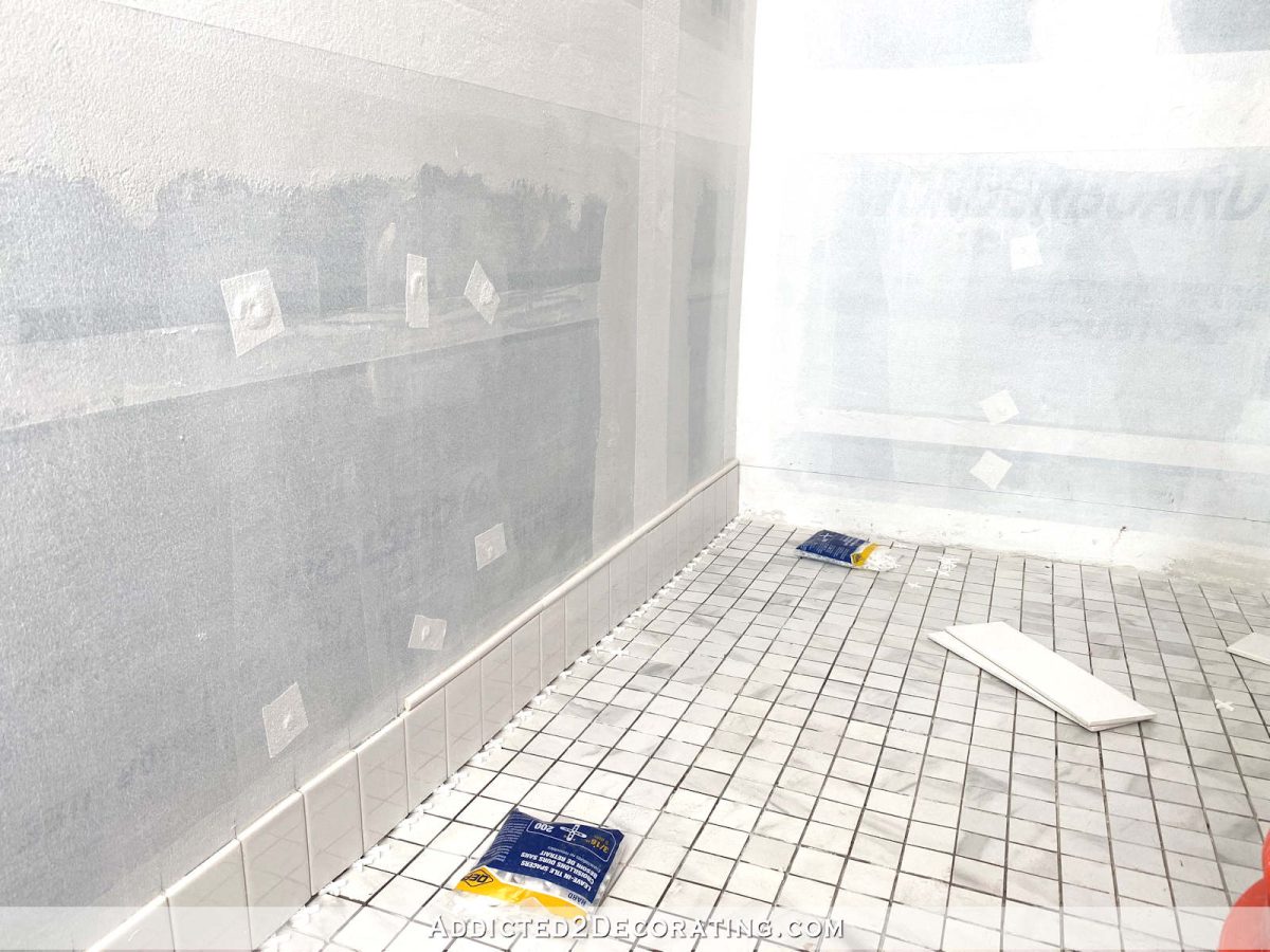 tiling the bottom of the shower wall with a sloped shower floor - 4