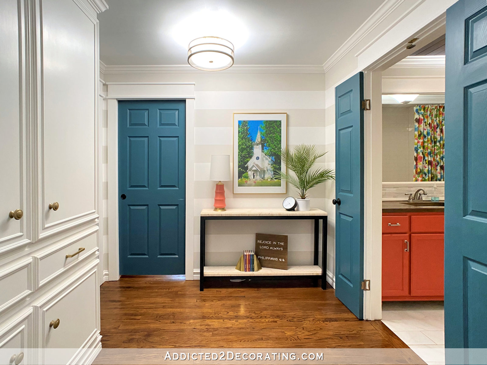 Interior hallway doors leading to bathroom and bedrooms painted dark teal