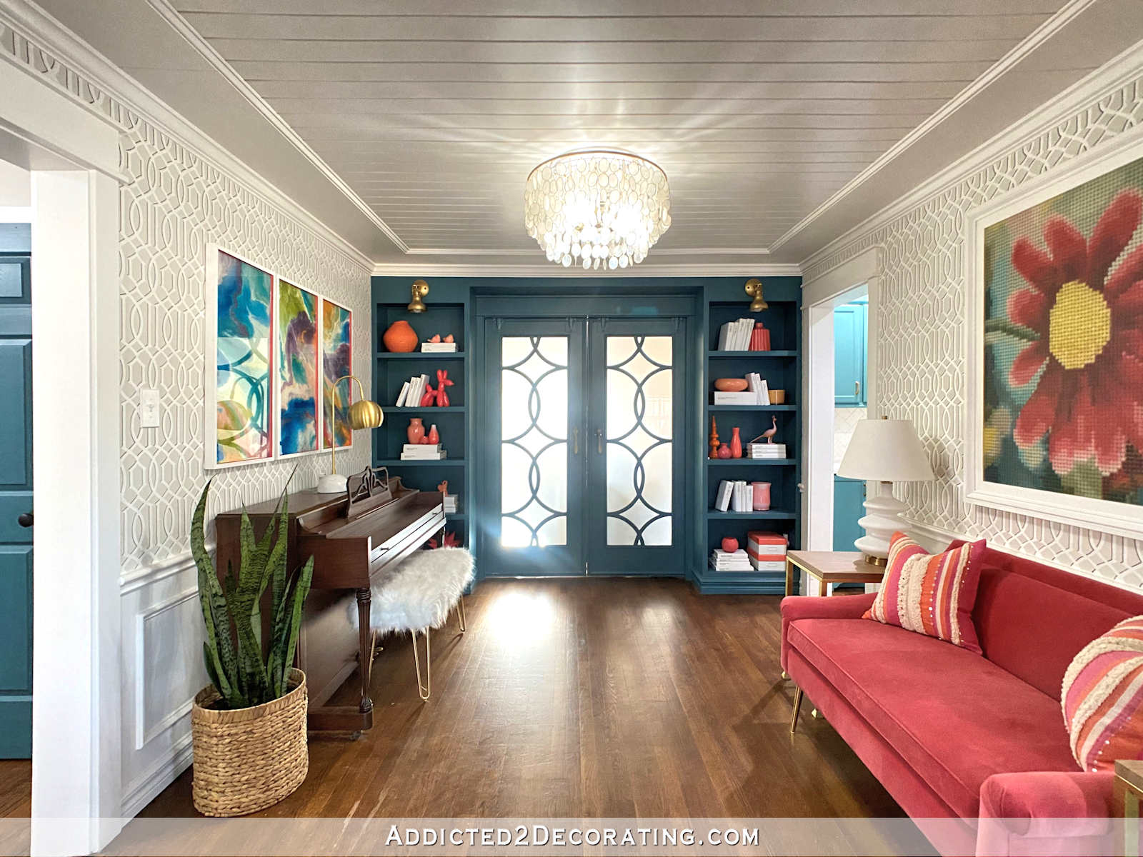 colorful piano room with wood slat ceiling, stenciled walls, and built-in bookcases