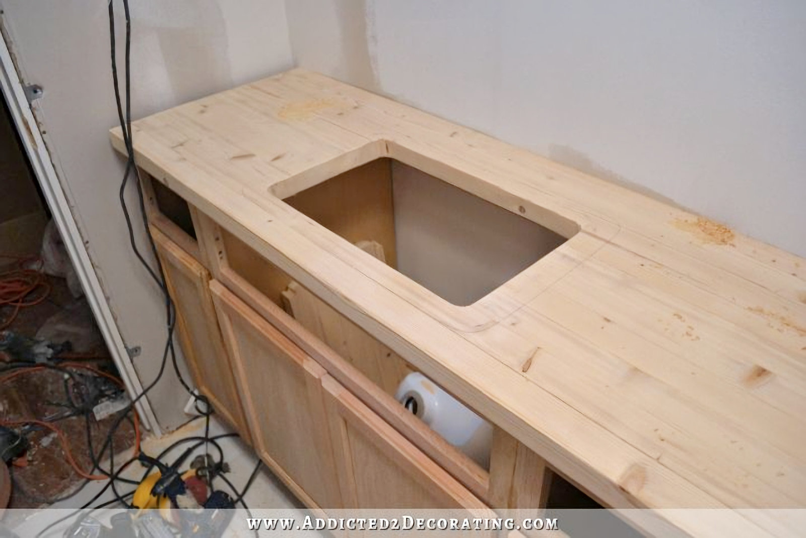 DIY pine butcherblock style countertop with hole cut out for undermount sink