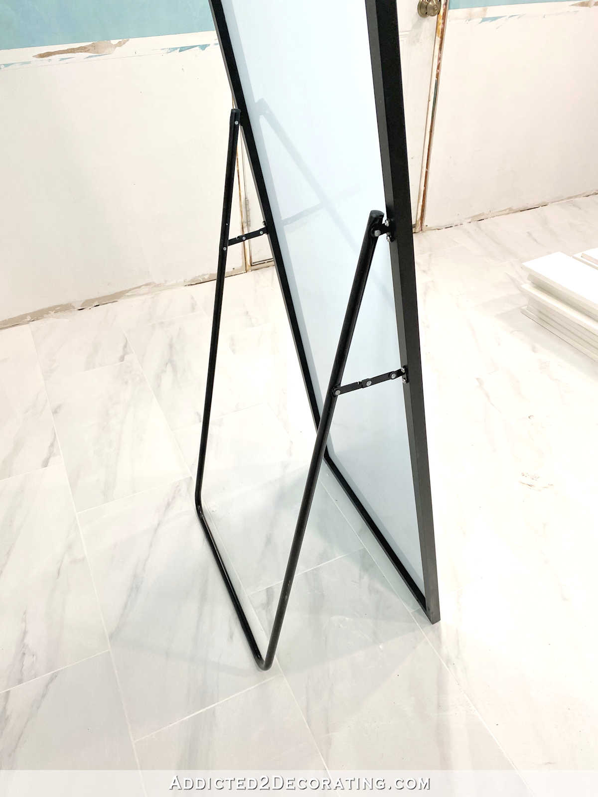 black framed floor mirror -- stand can be removed with a screwdriver so the mirror can be hung on the wal