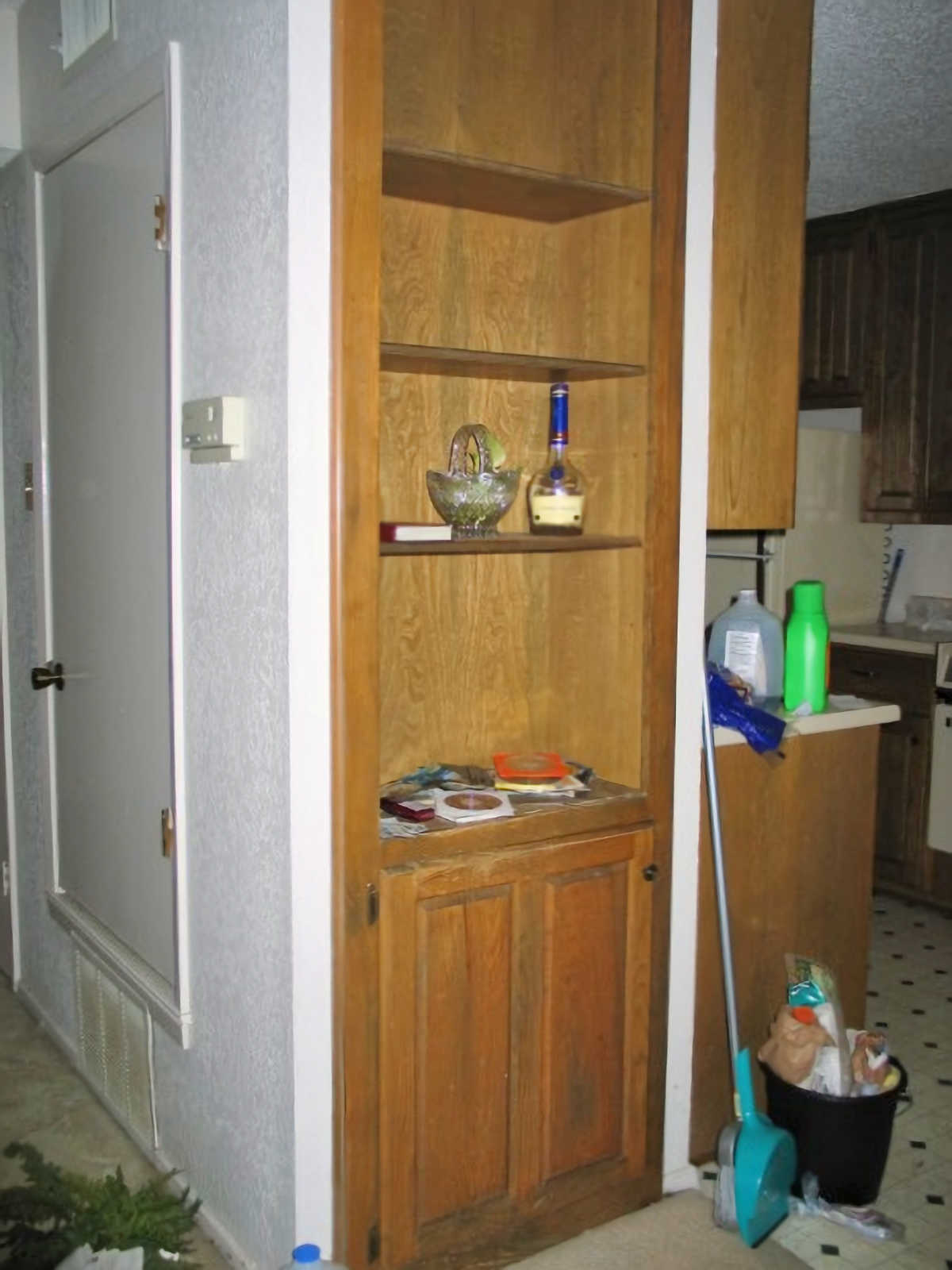 condo built-in bookshelves before remodel - bookcase near the kitchen was turned into a pantry