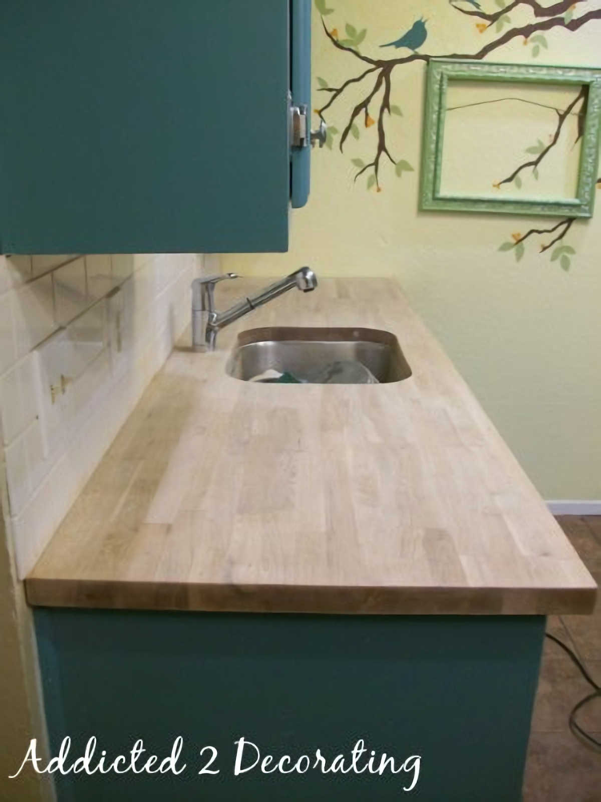 freshly sanded oak butcher block countertop in a small condo kitchen