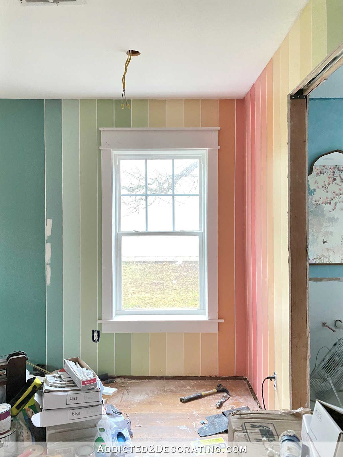 vertical striped rainbow walls with white trim on windows