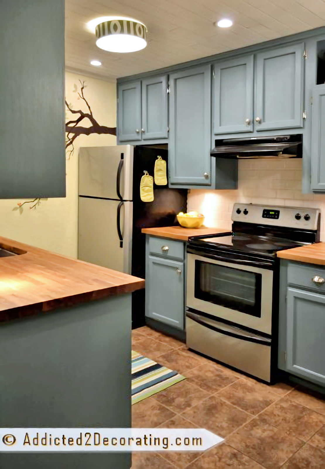 tiny condo kitchen with teal cabinets with yellow walls