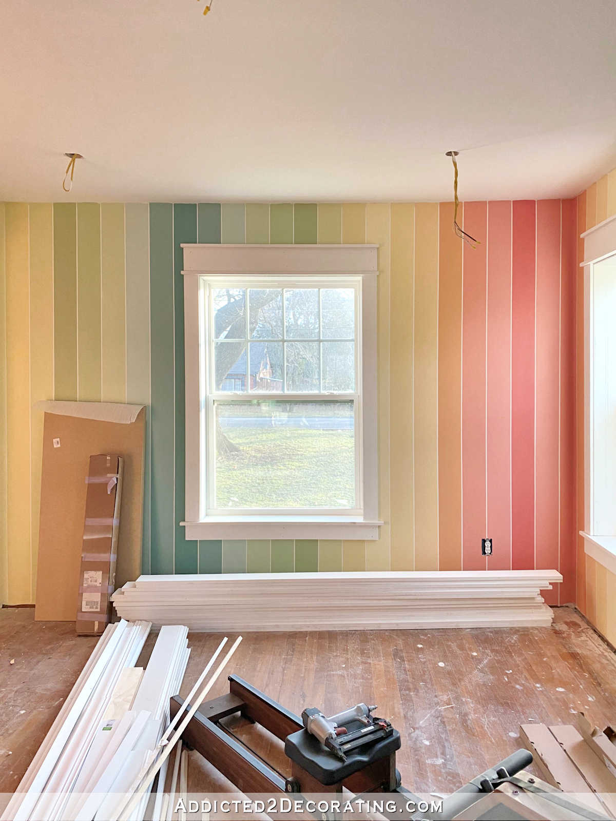 vertical rainbow stripes painted on wall, white window trim