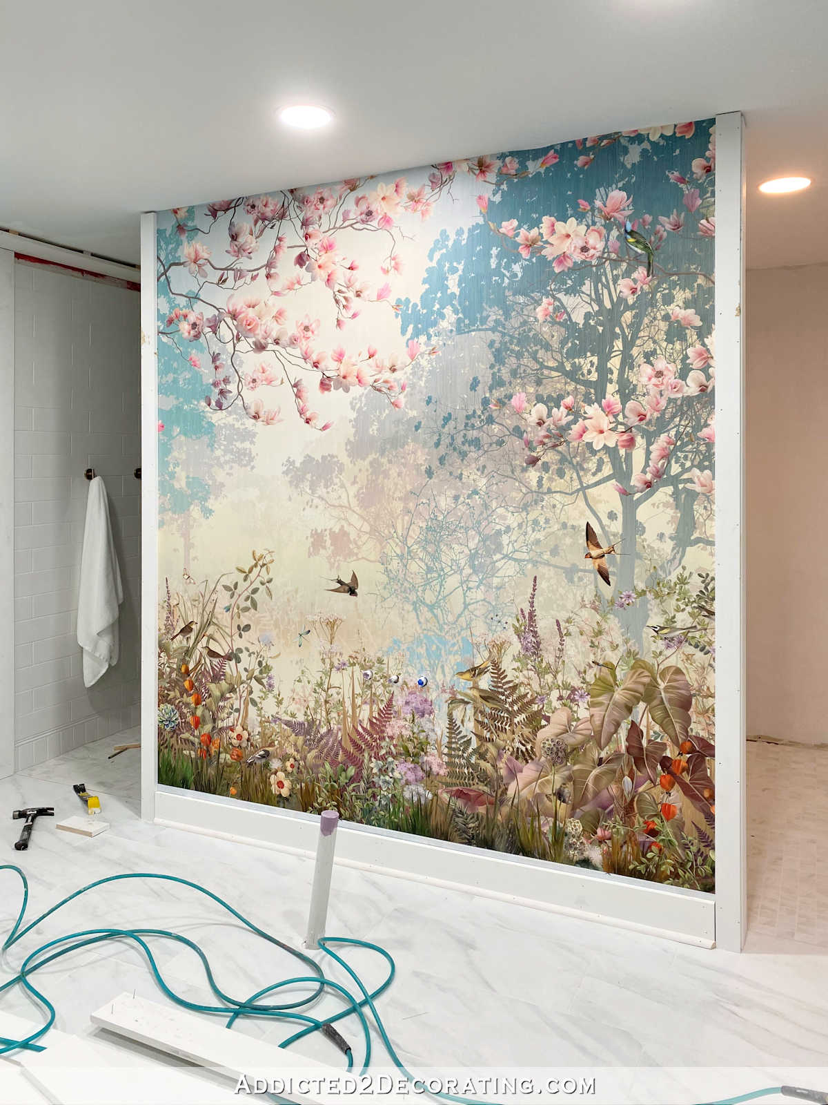 colorful wallpaper mural of forest scene in teals, pinks and greens in master bathroom