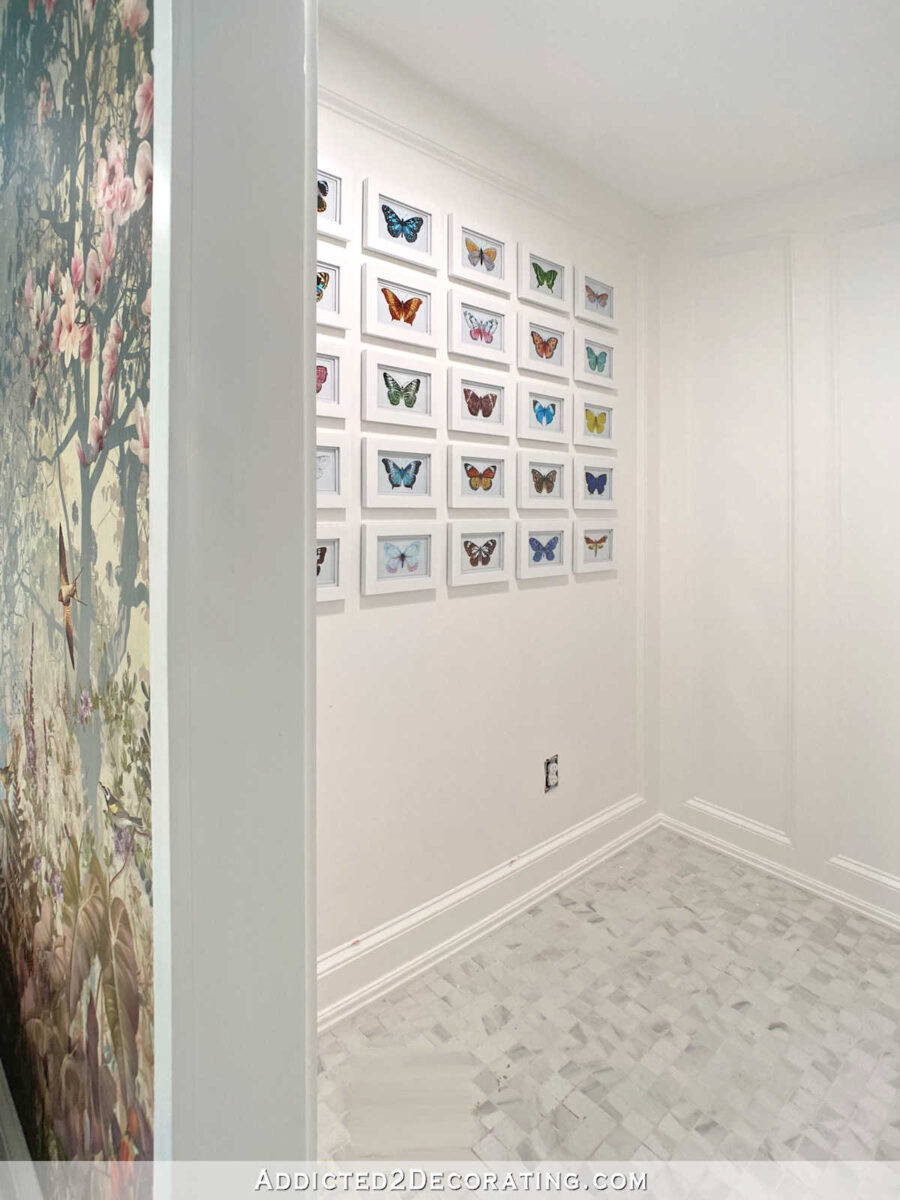 Butterfly gallery wall in the water closet area of a master bathroom