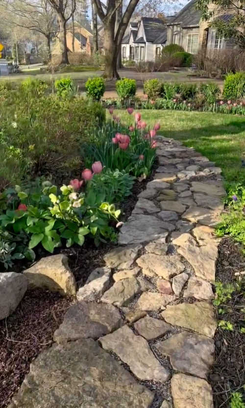 Field stone border around flower beds from The Psychiatrist's Garden on Instagram
