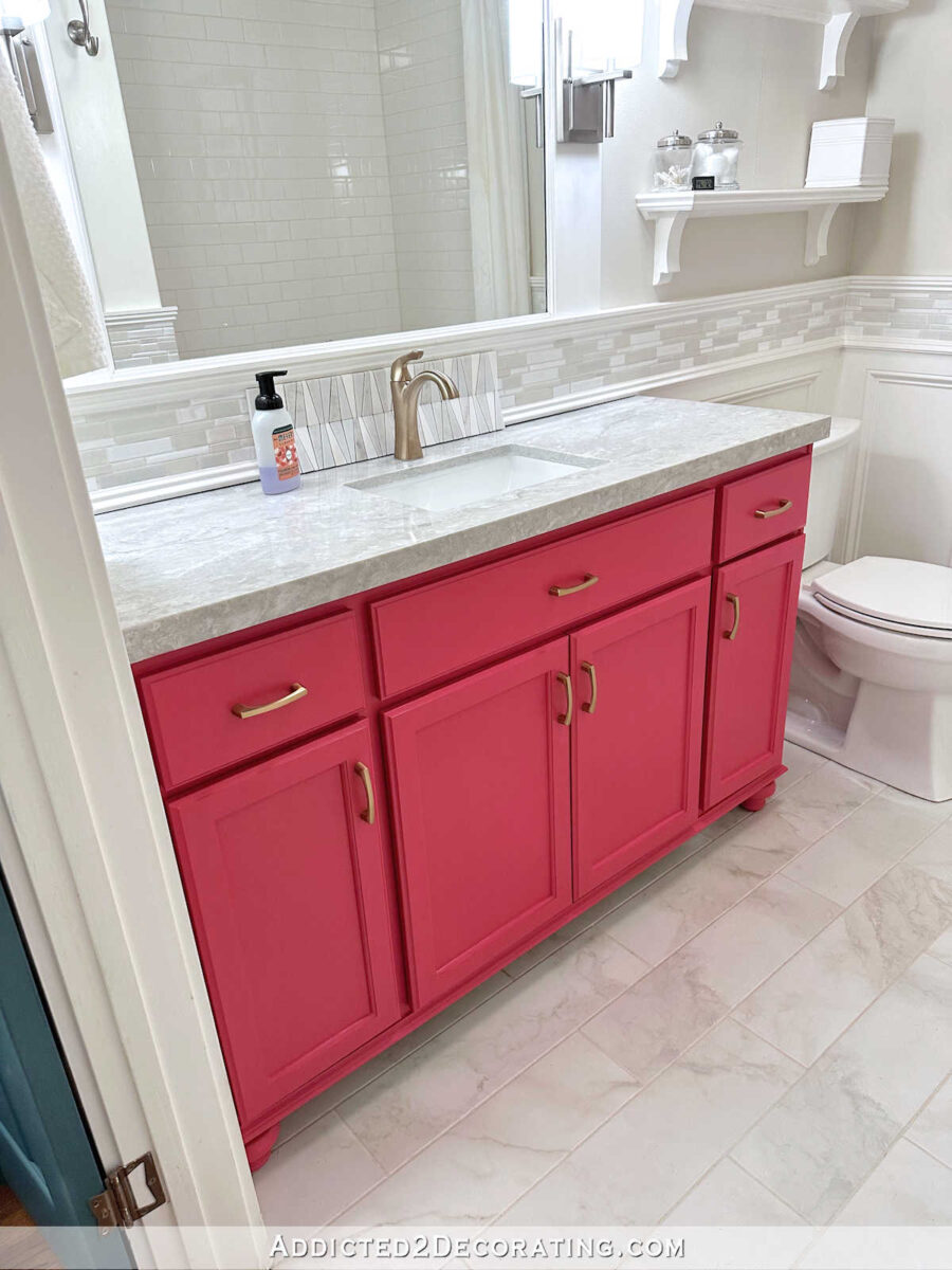 bathroom with light gray and white quartz countertop, pink vanity