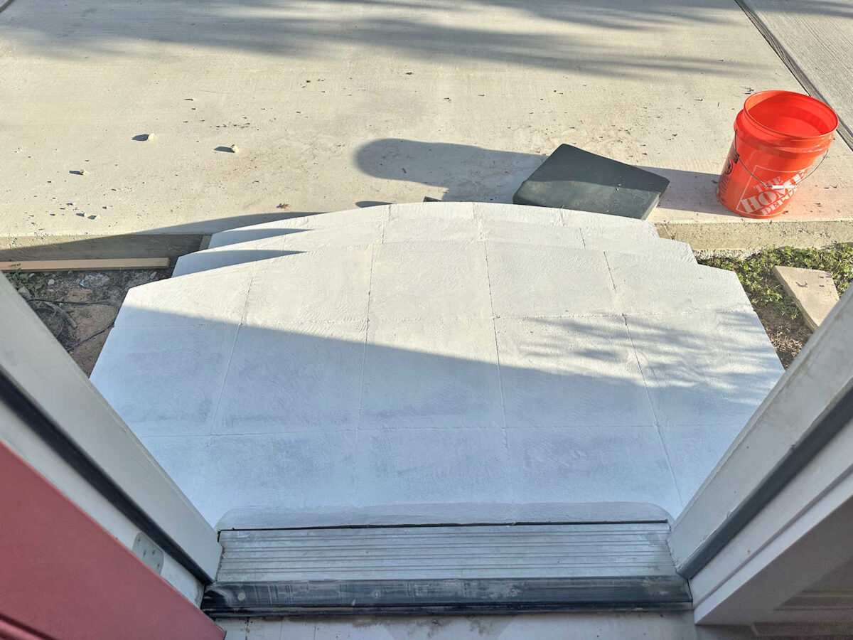 View of DIY exterior concrete steps from doorway -- primed and ready for paint